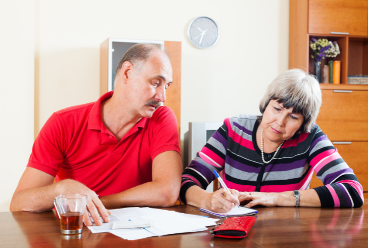 Retirees review monthly income and budget