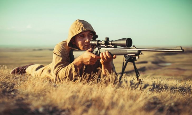 What legal requirements must you consider when selecting a firearm for hunting?