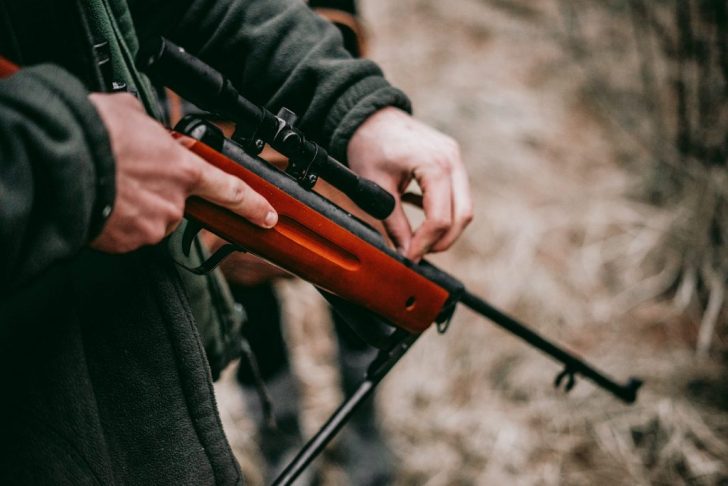 What legal requirements must you consider when selecting a firearm for hunting?